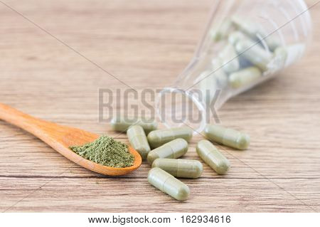 Green Herb Powder Capsules And Erlenmeyer Flask