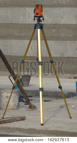 Close-up to automatic level tripod in construction site