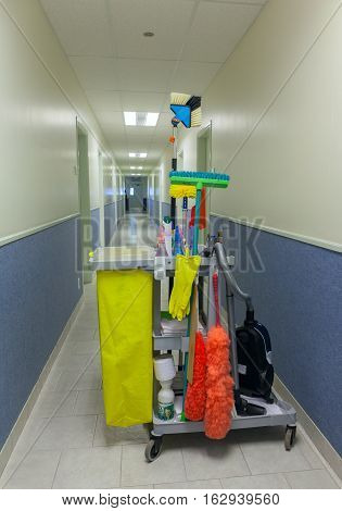 Bucket with cleaning items in a corridor. Stock photo