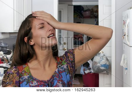 Beautiful forgetful woman with her hand on her forehead