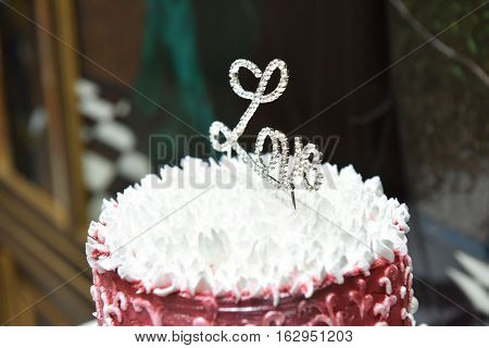 wedding red white cake on a table with topping