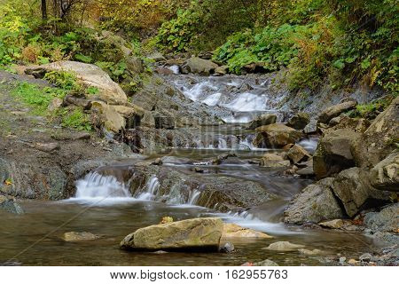 Waterfall in Mykulychyn. Ivano-Frankivska oblast Ukraine. Autumn landscape.