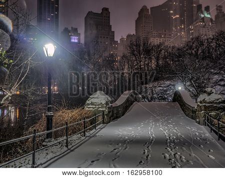Gapstow Bridge is one of the icons of Central Park Manhattan in New York City during snow storm at night
