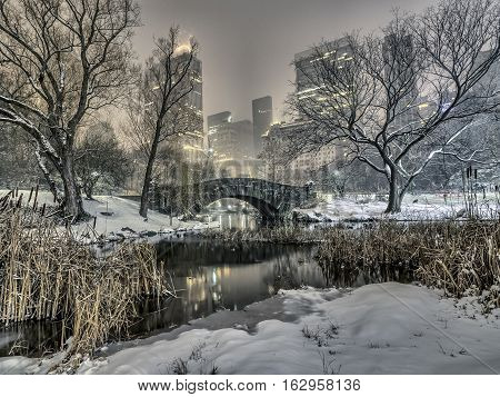Gapstow Bridge is one of the icons of Central Park Manhattan in New York City during snow storm at night