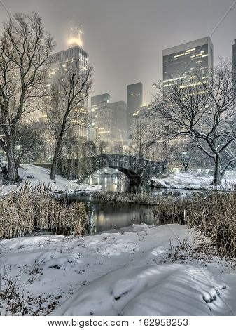 Gapstow Bridge is one of the icons of Central Park Manhattan in New York City during snow storm at night
