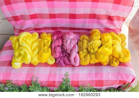 Raw, unprocessed silk yarn from yellow cocoons of the silk worm.