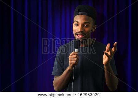 young man in concert blue theater comedy vocalist singer microphone