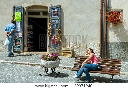 Pescocostanzo Italy - August 19 2006: A young local woman sunbathing in the country center