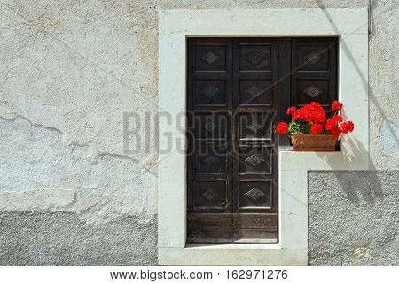 Italy Pescocostanzo an ancient entrance door with flowers in the country center