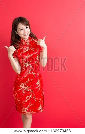 beauty woman wear cheongsam and thumb up with chinese new year