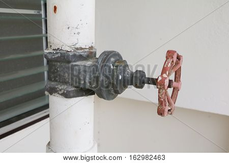 Close up water valve plumbing steel that is rust industrial tap pipe