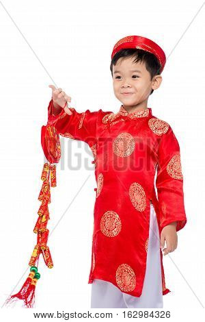 Portrait of a funny and exciting Vietnamese boy with firecrackers. Asian Kid Celebrating New Year