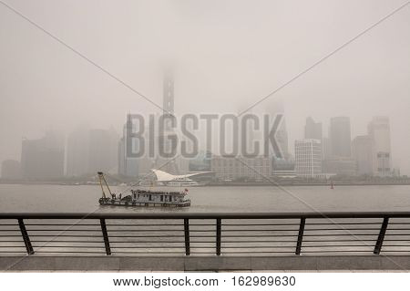 Shanghai China - April 20 2010: Severe pollution hangs over city Pudong Business District Buildings at Lujiazui are shrouded in heavy smog.