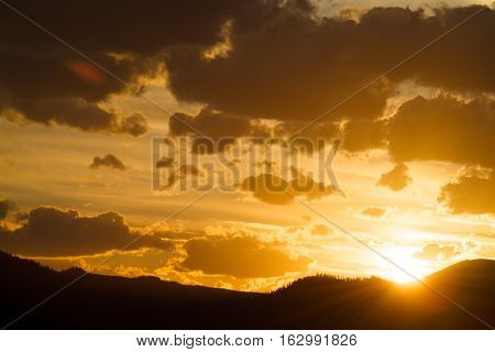 Sun seting over the Sayan mountains at tayga