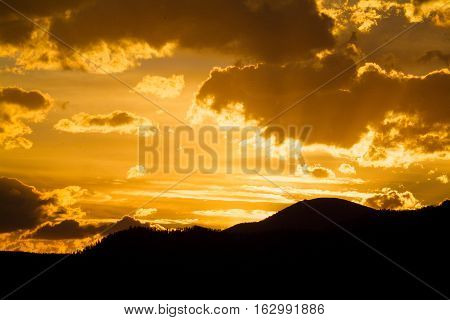 Sun seting over the Sayan mountains at tayga