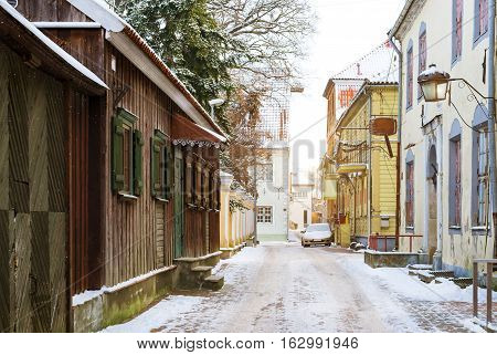 Architectural diversity in centre of resort Estonian town Parnu. Historic brick and wooden buildings and attractions. Snow-covered streets of tourist Baltic city in winter