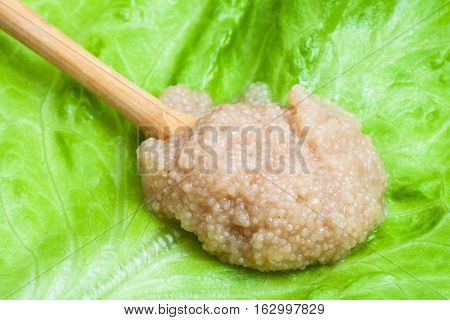 Caviar Of Herring In Wooden Spoon On Green Leaf