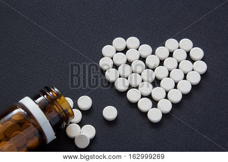 Meny different white pills. Medicine background from much capsules and pills. Drugstore set. Medicine Pills. heart