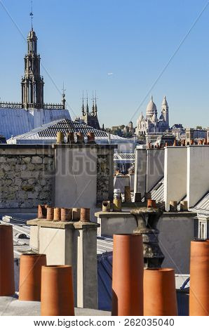 The Roofs Of Paris And Its Chimneys Under A Clouds Sky