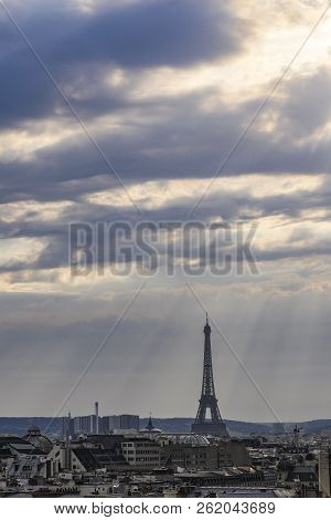 The Roofs Of Paris And Its Chimneys Under A Clouds Sky