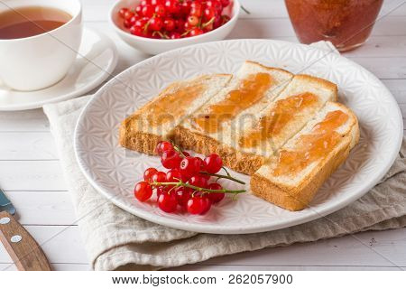 Healthy Breakfast With Toast, Jam And Red Currants, A Cup Of Cof