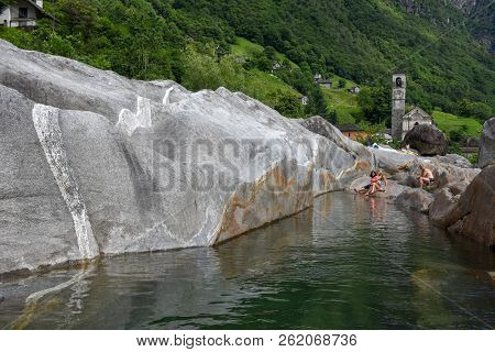 People Sunbathing On The River At Lavertezzo In Switzerland