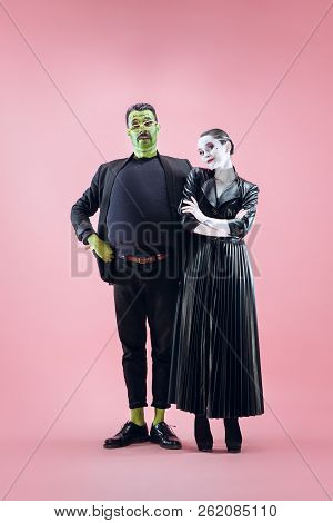 Halloween Family. Happy Couple In Halloween Costume And Makeup. Bloody Theme: The Crazy Maniak Faces