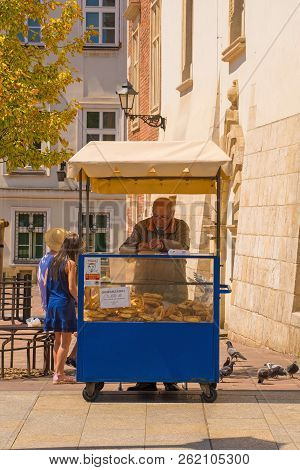 Krakow, Poland - July 13th 2018. A Vendor Sells Obwarzanek Krakowski From His Stall On Grodzka Ulica
