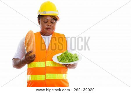 Studio Shot Of Fat Black African Woman Construction Worker Holdi