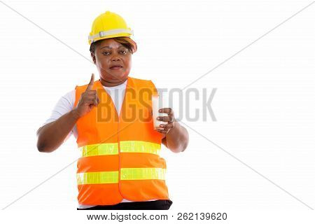 Studio Shot Of Fat Black African Woman Construction Worker Holdi