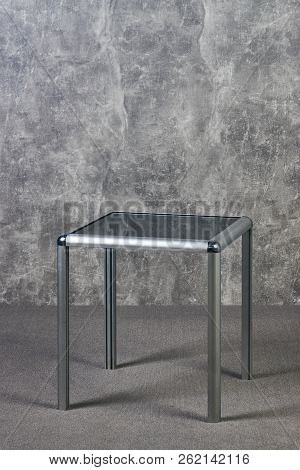 Modern Glass Table Top On Gray Texrure Wall Background