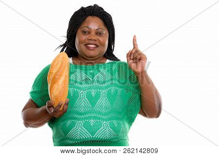 Studio Shot Of Happy Fat Black African Woman Smiling While Holdi