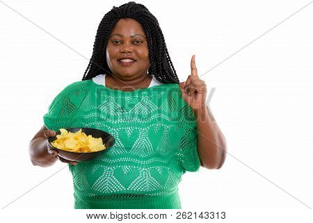 Studio Shot Of Happy Fat Black African Woman Smiling While Holdi