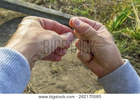 Fisherman Tying A Hook. Tie The Kd Rig.