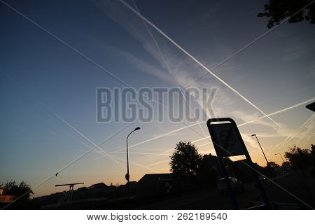 Sunrise With Colored Aircraft Trails, Fog On The Meadows And Dyke At River Hollandsche Ijssel In The