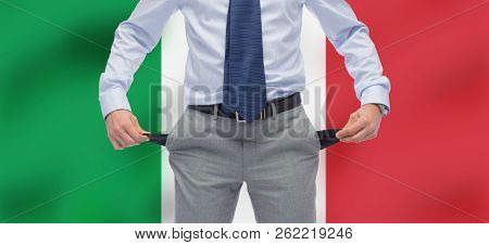 business, bankruptcy and finance crisis concept - close up of businessman showing empty pockets over flag of italy background