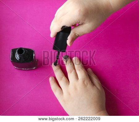 Children's Hands Paint Their Nails With Black Nail Polish. Children's Manicure. Black Manicure On Ch