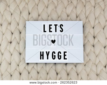Lets Hygge Word On Lightbox On Knit Background. Cozy Compozition. Knit Background.