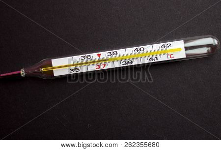 A Termometr With High Temperature On A Black Background With