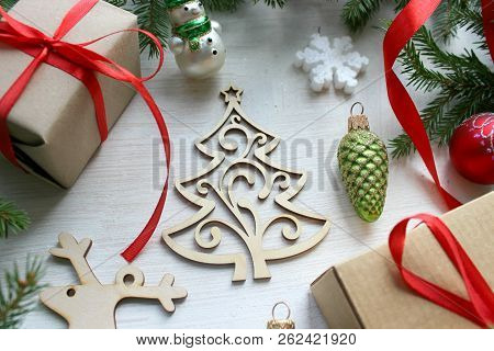 New Year. Christmas Wooden White Background With Christmas Tree Branches And Christmas Decorations. 