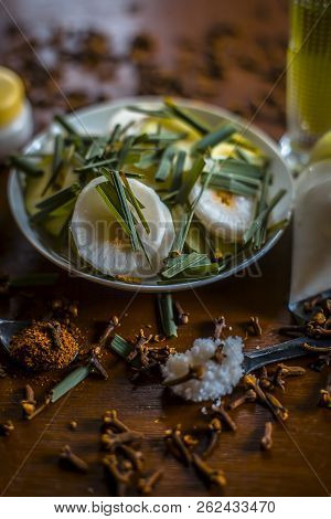 Close Up Of Organic Salad Of White Radish With Spring Onions,olive Oil,black Pepper,salt And Clove P