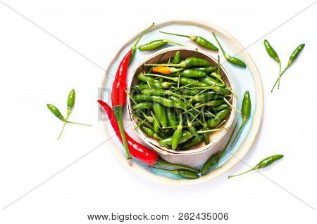 Food Concept Chili Padi, Bird's Eye Chili, Thai Pepper And Red Chili On Bamboo Tray With Copy Space