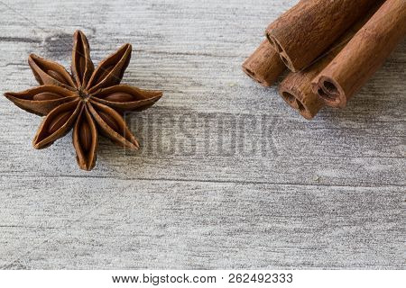 Anise Star Spices And Cinnamon Sticks On Grey Rystic Wooden Background, Close Up, Macro.
