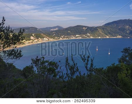 Panoramic View Of Agios Georgios Pagon Sand Beach With Green Hills And Sailing Ships At Corfu Island