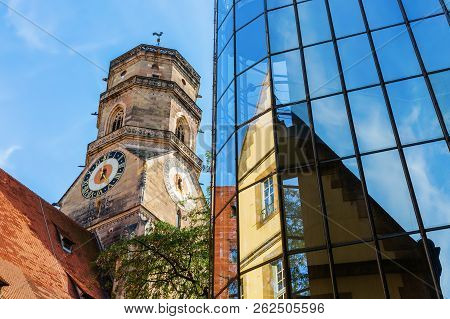 Stiftskirche With Reflections In A Glass Facade In Stuttgart, Germany
