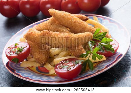 Deep fried chicken frites with potato chips or french fries