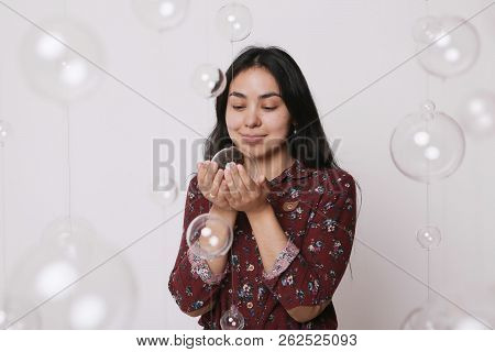 Beautiful Girl Among The Glass Balls One Of Which She Holds In Her Hands