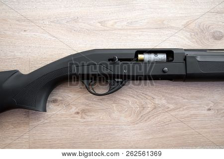 Semi-automatic Black Hunting Shotgun And Cartridges 12 Gauge, Close-up View