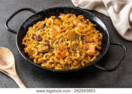 Traditional Spanish Fideua. Noodle Paella On Black Stone.