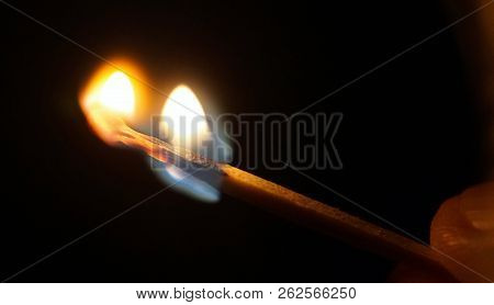 Flame Of The Match Burning In Fingers In The Dark